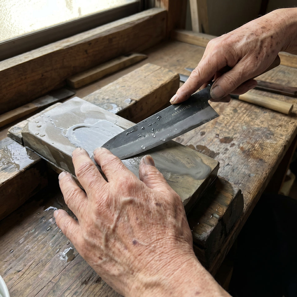 A Masahira blade being finished by hand on a whetstone